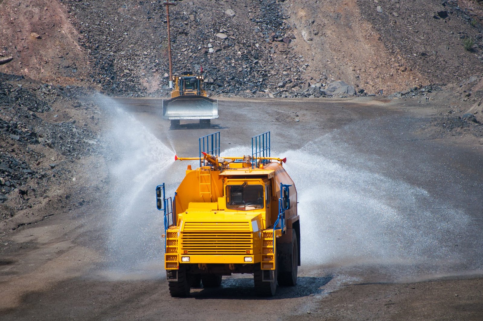 Watering ground to reduce dust formation